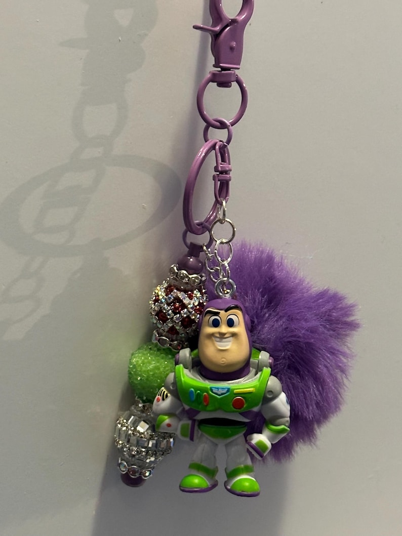 May include: A white ceramic mug with a black handle and the text "But First, Coffee" in a black, bold font. The mug is on a white surface.