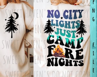 May include: A white sweatshirt with a black graphic design on the front and back. The front design is a black silhouette of a pine tree with a crescent moon and stars. The back design says "No City Lights Just Camp Fire Nights" in a retro font with a campfire and pine trees.