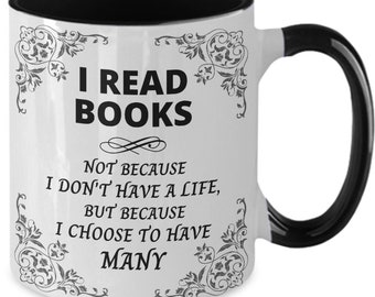 May include: White ceramic coffee mug with a black rim and handle. The mug features a black and white design with the text "I read books not because I don't have a life, but because I choose to have many."