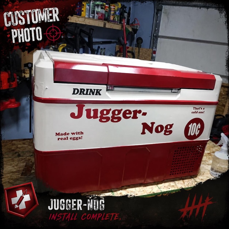 May include: A red and white chest-style cooler featuring the text DRINK Jugger-Nog, That's a cold one!, Made with real eggs!, and a 10 cent price graphic. The cooler has a rectangular lid, a smooth finish, and a ventilation grate on the side.