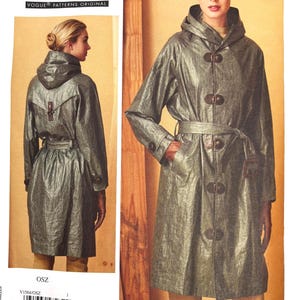 May include: A sewing pattern for a hooded trench coat with toggle closures and a belt. The pattern is from Vogue Patterns and includes the text "TODAY'S FIT BY SANDRA BETZINA VOGUE PATTERNS ORIGINAL". The pattern number is V1564.