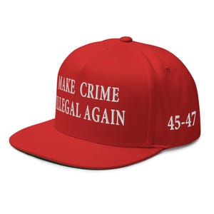 May include: A red baseball cap with a flat peak. The cap has white embroidered text: "MAKE CRIME ILLEGAL AGAIN" and "45-47". A classic, casual hat.
