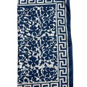 May include: A blue and white cotton fabric with a floral pattern and a white Greek key border.