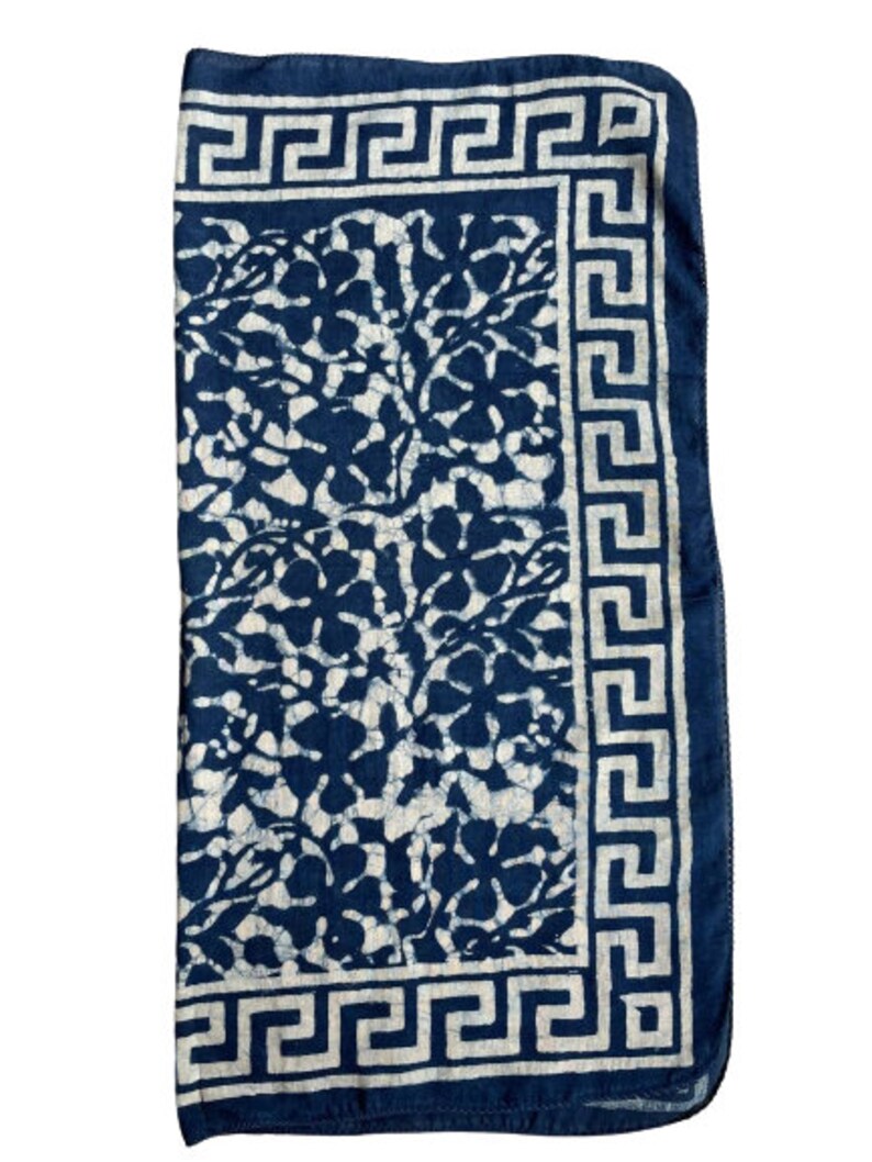 May include: A blue and white cotton fabric with a floral pattern and a white Greek key border.
