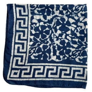 May include: A blue and white cotton bandana with a floral pattern and a white greek key border.