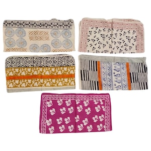 May include: Five folded fabric items with various block print designs. The patterns include floral, geometric, and abstract motifs in colors like blue, brown, orange, and pink. The fabrics appear to be cotton or a similar material, suitable for home decor or crafting.