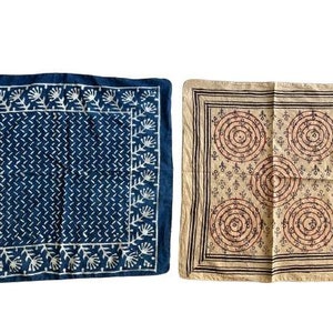 May include: Two square cotton bandanas with different patterns. The first bandana is dark blue with a white floral pattern. The second bandana is beige with a brown and pink geometric pattern.