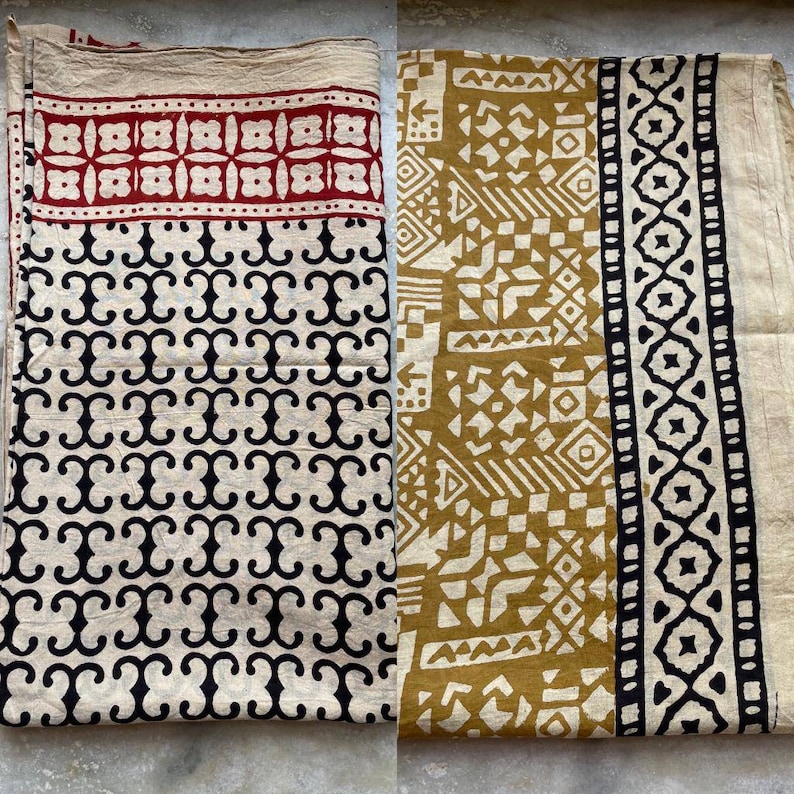 May include: Two fabric squares with different geometric patterns. The square on the left has a black and white pattern of repeating swirls. The square on the right has a mustard yellow and white pattern of geometric shapes.