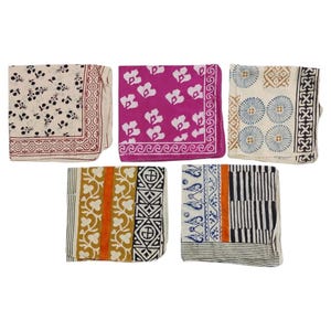 May include: Five folded square bandanas with various patterns. Designs include floral, geometric, and striped motifs in colors like cream, fuchsia, blue, and black. Each bandana has a patterned border.
