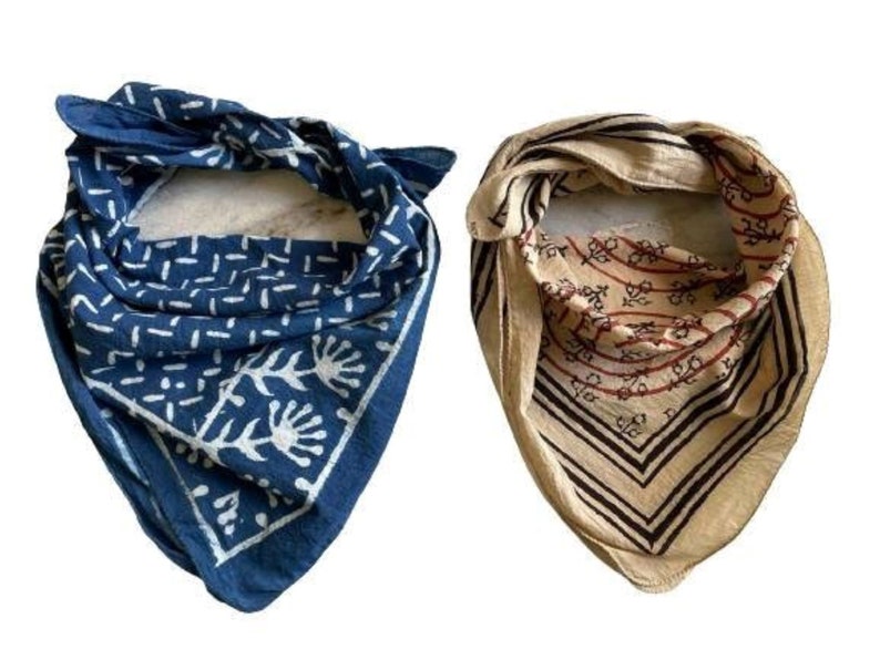 May include: Two cotton bandanas, one blue with a white geometric pattern and one beige with a brown and red floral pattern.