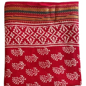 May include: Red cotton fabric with a white paisley pattern and a gold, black and red border.