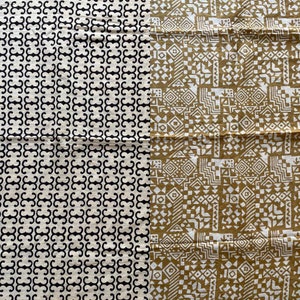 May include: Two fabric swatches with geometric patterns. The left swatch has a black and white repeating pattern. The right swatch has a white and gold repeating pattern.
