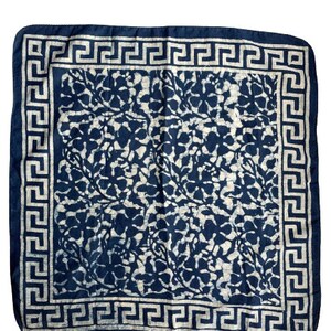 May include: A blue and white cotton bandana with a floral pattern and a white Greek key border.