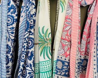 May include: Three cotton scarves with floral and striped patterns. The scarves are in shades of blue, pink, and green.