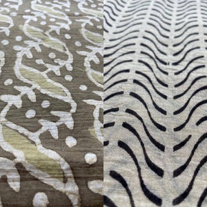 May include: Close-up of two fabric patterns. One features a repeating design of white and light green leaf-like shapes on a brown background. The other has a wavy black line pattern on a light beige background. Both fabrics appear to be textured.