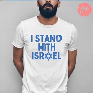 May include: A white t-shirt with blue text that reads "I Stand With Israel" and a blue Star of David.