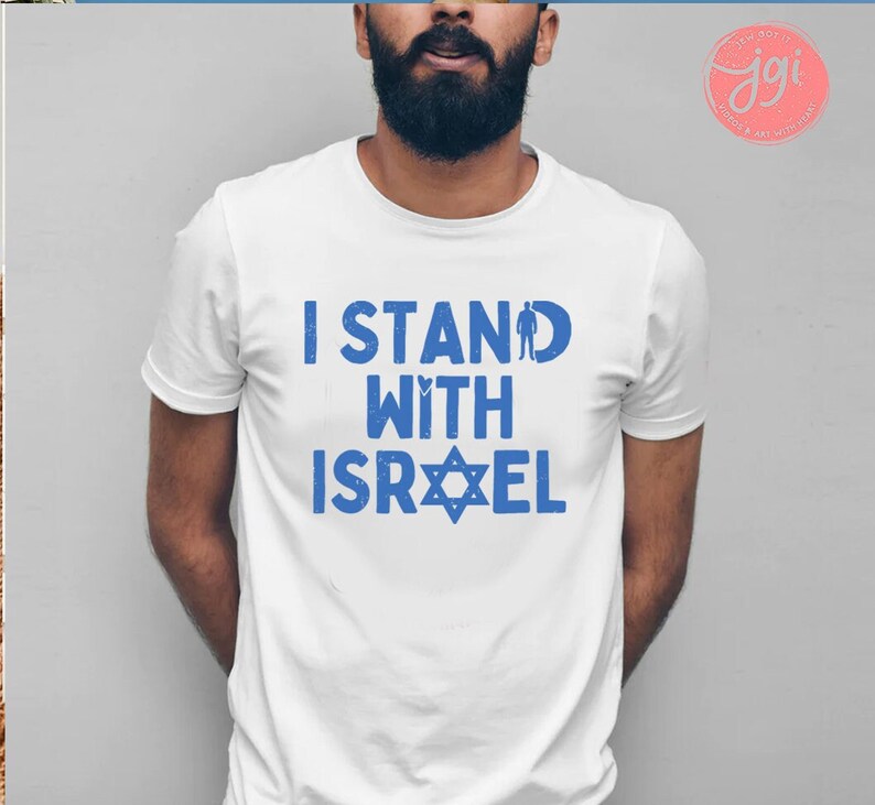 May include: A white t-shirt with blue text that reads "I Stand With Israel" and a blue Star of David.
