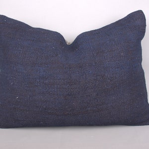 May include: A dark blue throw pillow with a woven texture.