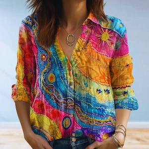 May include: A vibrant, button-down shirt with a colorful, abstract design. The shirt features a V-neck collar and long sleeves. The color palette includes shades of pink, yellow, blue, and orange. The shirt has a unique, artistic pattern.