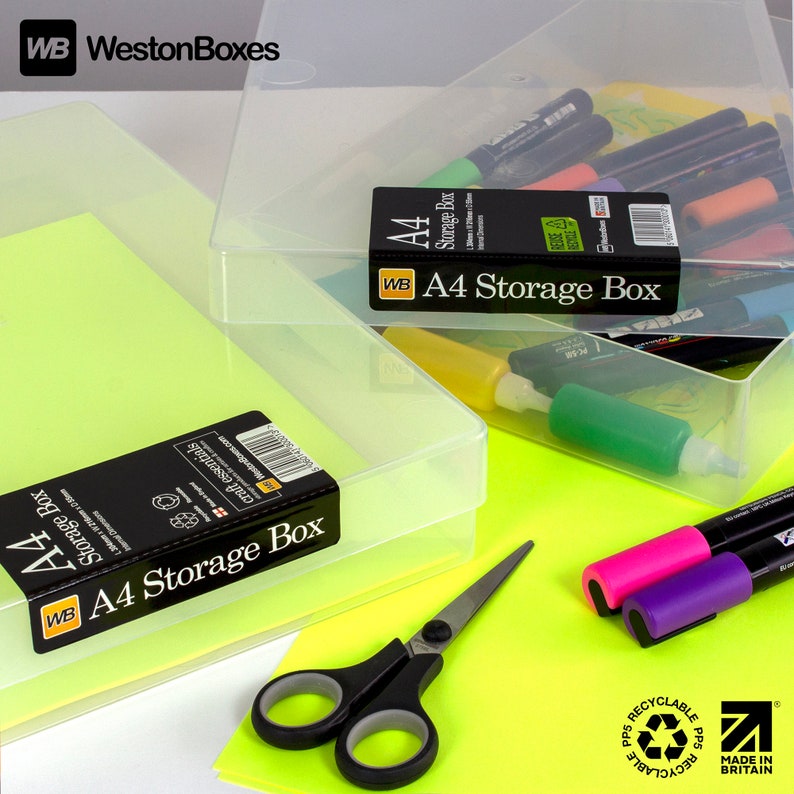 May include: Two clear plastic storage boxes with the label "A4 Storage Box" on the front. The boxes are made of recyclable polypropylene and are made in Britain. The boxes are sitting on a bright yellow surface with a pair of scissors and markers.