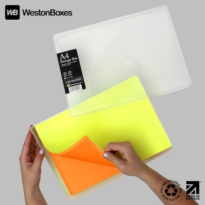 May include: A clear plastic storage box with a yellow and orange sheet of paper inside. The box is labeled "A4 Storage Box" and "craft essentials". The box is made of recyclable polypropylene and is made in Britain.