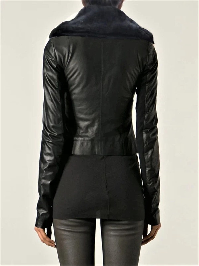 May include: Black leather jacket with a faux fur collar. The jacket has a cropped fit and long sleeves.