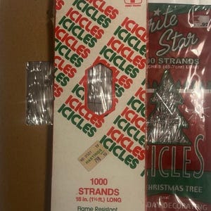 Three boxes of Vintage Silver Tinsel/Icicles 1000 strands each box.