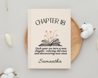 May include: A personalized book cover with the text "CHAPTER 18" in black. Below, an open book graphic with floral accents. The text reads "Each year we turn a new chapter, reliving old ones and discovering new ones" and "Samantha".