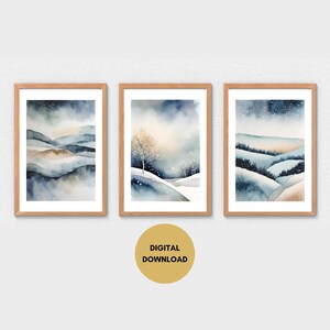 May include: Set of three digital watercolor prints featuring snowy landscapes with blue and gold hues. The prints depict rolling hills, trees, and a starry sky.