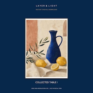 May include: A digital art print titled COLLECTED TABLE I by LAYER & LIGHT featuring a deep blue ceramic pitcher, three yellow lemons, and an olive branch resting on a white cloth against a textured beige and terracotta wall background.