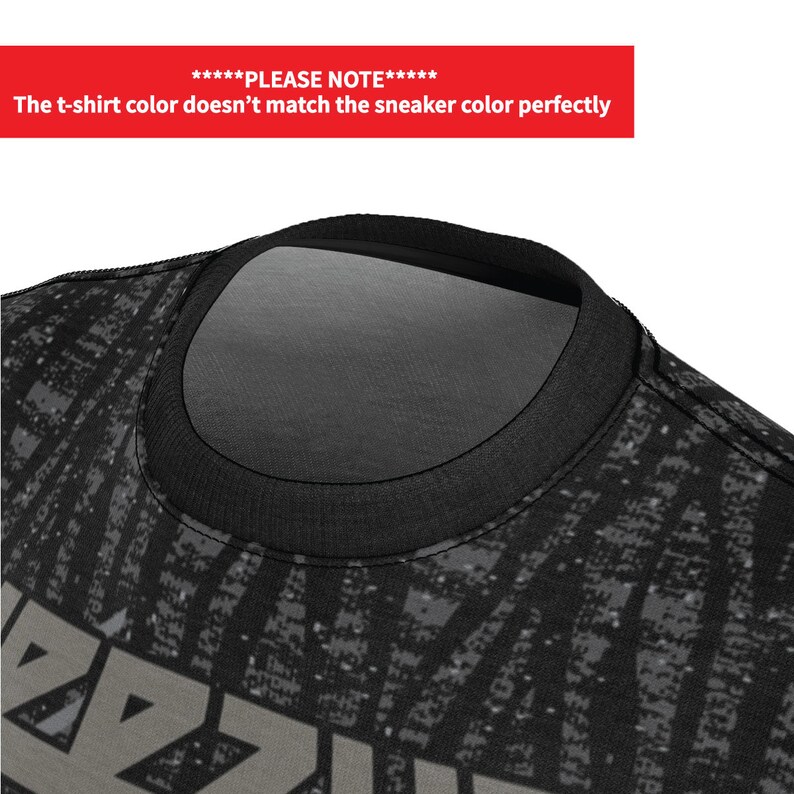 May include: Black t-shirt with a grey and black pixelated design and the word "RAZOR" printed in grey on the front.