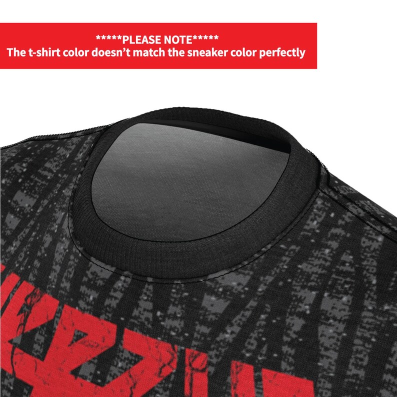 May include: Black t-shirt with a red graphic print of the word "AZZZUL" in a distressed style. The t-shirt has a black crew neck.
