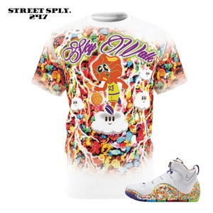 May include: White t-shirt with a colorful cereal print and a cartoon basketball player on a cloud. The text "Sky Walk" is written in purple on the shirt. White basketball shoes with a colorful cereal print.