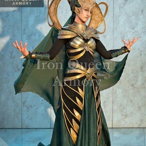 May include: A detailed costume with a gold and green color scheme. The outfit features a headpiece, shoulder armor, and a flowing skirt. The text "Iron Queen Armory" is visible on the image.