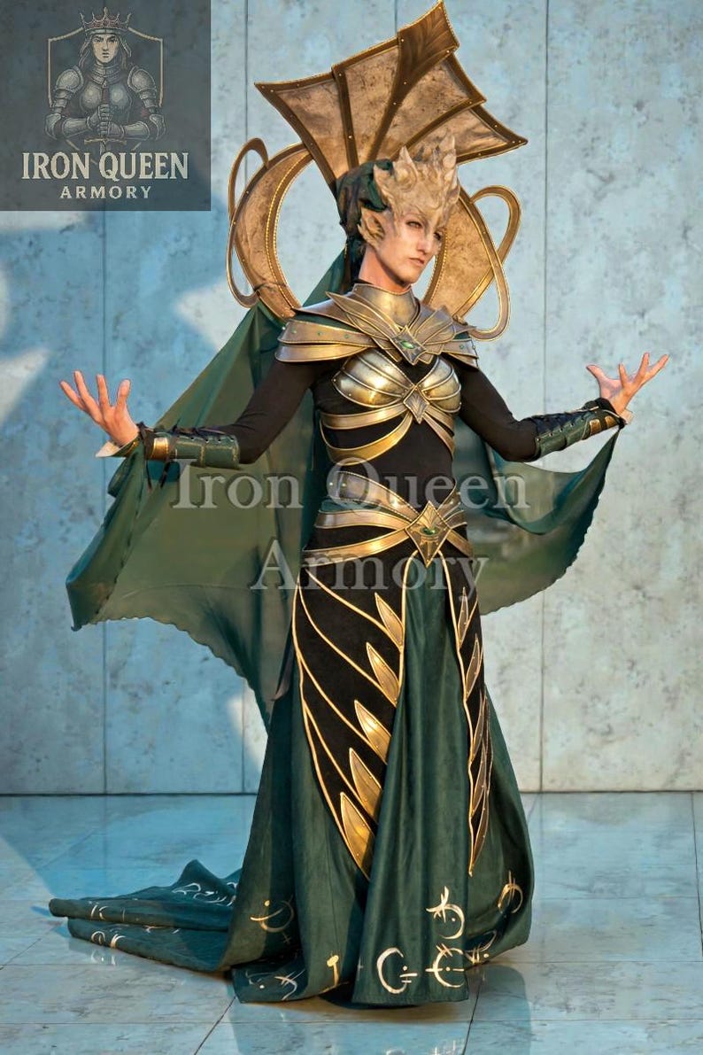 May include: A detailed costume with a gold and green color scheme. The outfit features a headpiece, shoulder armor, and a flowing skirt. The text "Iron Queen Armory" is visible on the image.