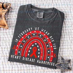 May include: A gray t-shirt with a red rainbow design and the text "In February we wear red for heart disease awareness".