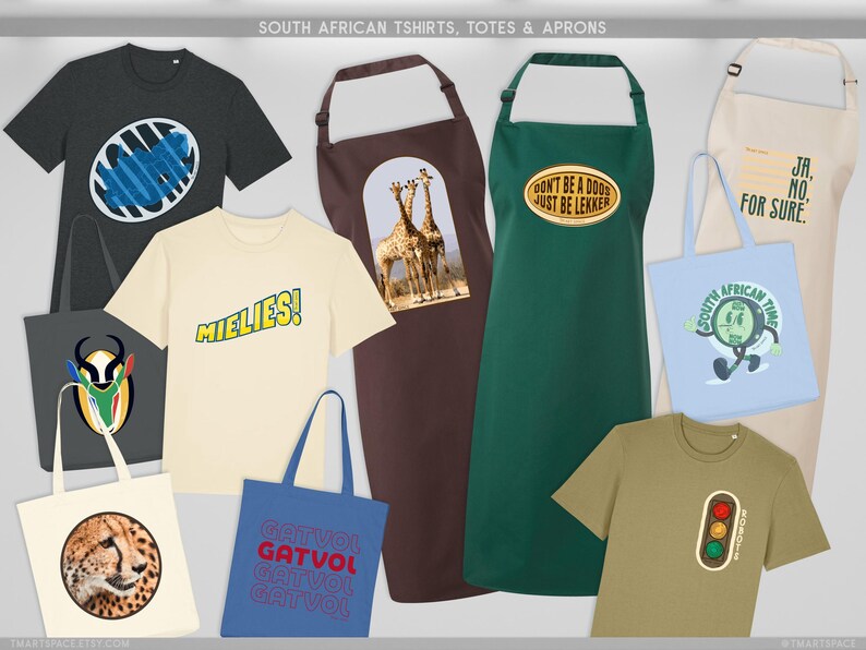 May include: A selection of South African themed t-shirts, tote bags, and aprons. The t-shirts feature various designs and text, including the word "MIELIES!". The aprons are brown, green, and beige. The tote bags are light blue, gray, and beige. The text "DON'T BE A DOOS JUST BE LEKKER" is visible.