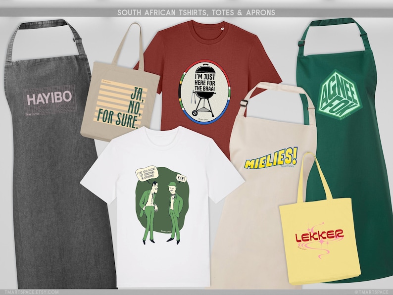 May include: A selection of South African themed aprons, tote bags, and t-shirts. The items display text and graphic designs. The aprons are grey, beige, and green. The t-shirts are red and white. The tote bags are beige and yellow.