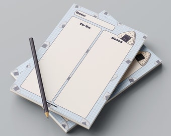 May include: A blue and white notepad with a grid pattern and a cartoon onigiri (Japanese rice ball) design. The notepad is divided into three sections: "Date", "To-Do", and "Notes".