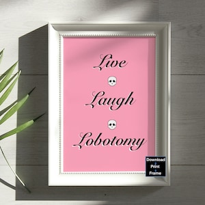 May include: A framed pink print with the text "Live Laugh Lobotomy" in black cursive font.  Each word is separated by a small black skull graphic.