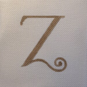May include: A gold-colored letter Z with a decorative flourish on a white canvas background.