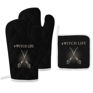 May include: A set of black quilted oven mitts and a pot holder with a white trim. The mitts and pot holder feature a graphic of crossed broomsticks with the text "#WITCH LIFE" in gold.