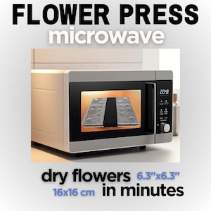 May include: A silver microwave with a glass door showing a black flower press inside. The microwave display shows "26:18". The text below the microwave reads "dry flowers 6.3"x6.3" 16x16 cm in minutes".