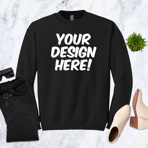May include: Black sweatshirt with the text "YOUR DESIGN HERE!" in white lettering.