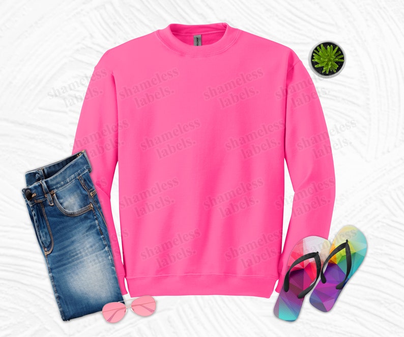 May include: A bright pink sweatshirt with the words "shameless labels." repeated in a pattern across the front.