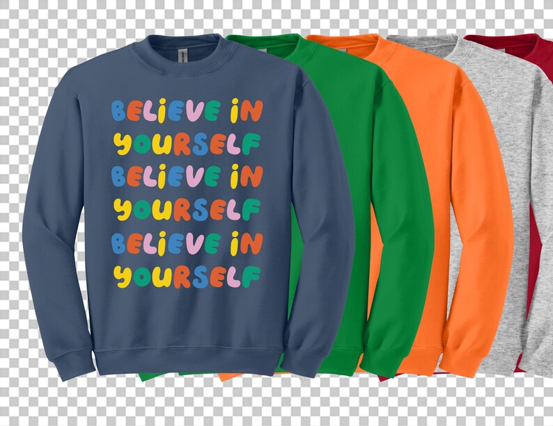 Może przedstawiać: Zestaw pięciu bluz w r&oacute;żnych kolorach, każda z nadrukiem "Believe in Yourself" na przodzie w kolorowych literach.