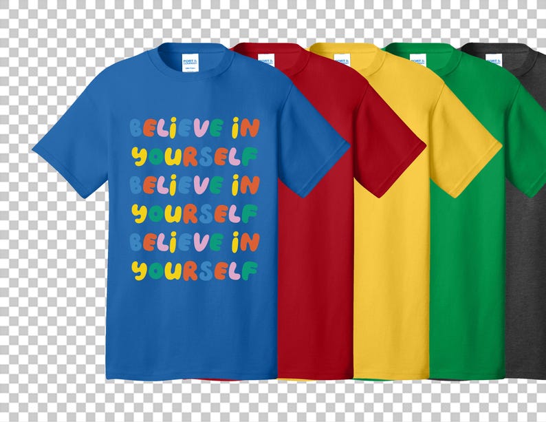 May include: A row of short-sleeved t-shirts in various colors: blue, red, yellow, green, and gray. The blue shirt features the text "BELIEVE IN YOURSELF" in colorful, bubble-style letters. The shirts are plain on the back.