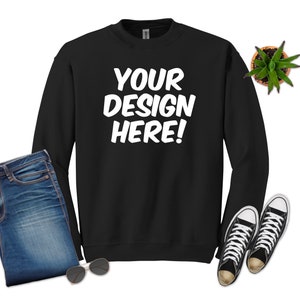 May include: Black sweatshirt with long sleeves and a crew neck. The sweatshirt has the text "YOUR DESIGN HERE!" printed in white on the front.