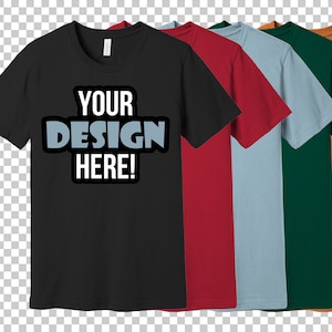 K&ouml;nnte beinhalten: F&uuml;nf T-Shirts in verschiedenen Farben: Schwarz, Rot, Hellblau, Gr&uuml;n und Orange. Das schwarze T-Shirt hat den Text "YOUR DESIGN HERE!" auf der Vorderseite.