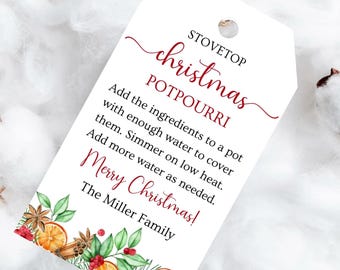 May include: A white tag with a brown string, featuring the text "STOVETOP christmas POTPOURRI" in red script. The tag includes instructions and the words "Merry Christmas!" with a decorative border of oranges, cinnamon sticks, and greenery.